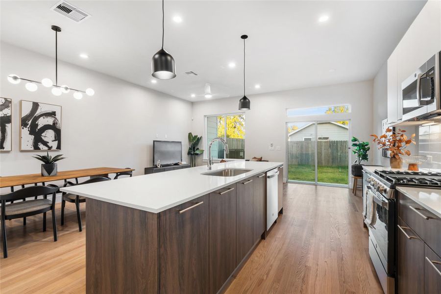 Sunlight pours in through the large windows & sliding glass doors, creating a bright, inviting atmosphere that extends to your covered patio. Sunlight pours in through the large windows & sliding glass doors, creating a bright, inviting atmosphere that extends to your covered patio.