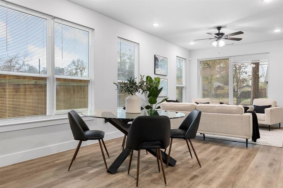 Dining room featuring ceiling fan and light wood-type flooring