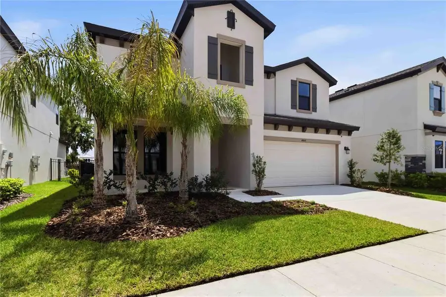 Front exterior of a new home in Hawkstone, Lithia, FL, highlighting curb appeal (Image 2). Front exterior of a new home in Hawkstone, Lithia, FL, highlighting curb appeal (Image 2).
