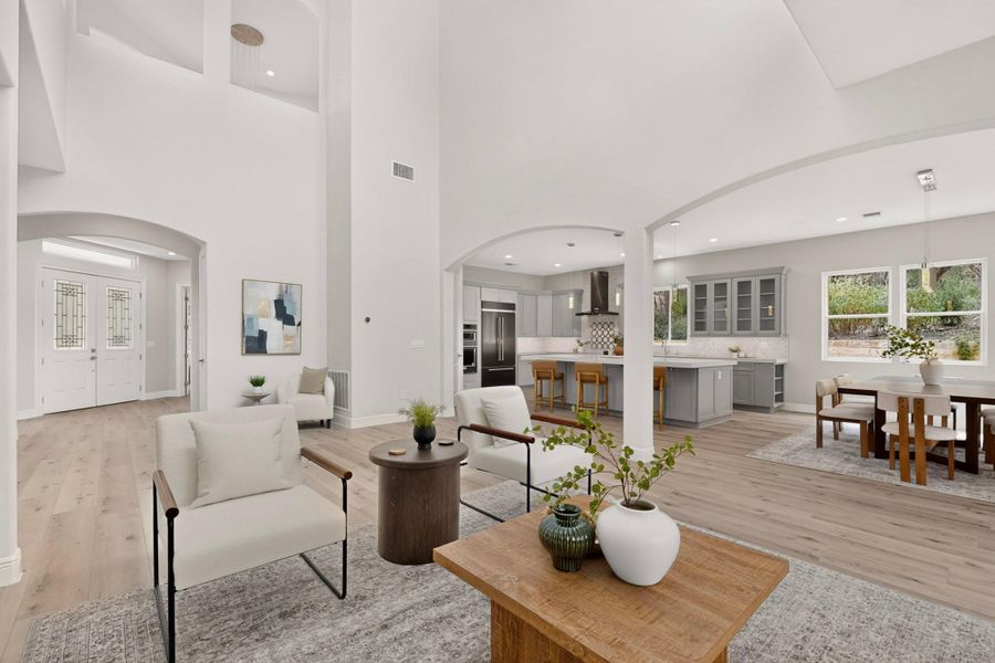 Arched openings and soaring ceilings connect the light-filled main living spaces seamlessly.