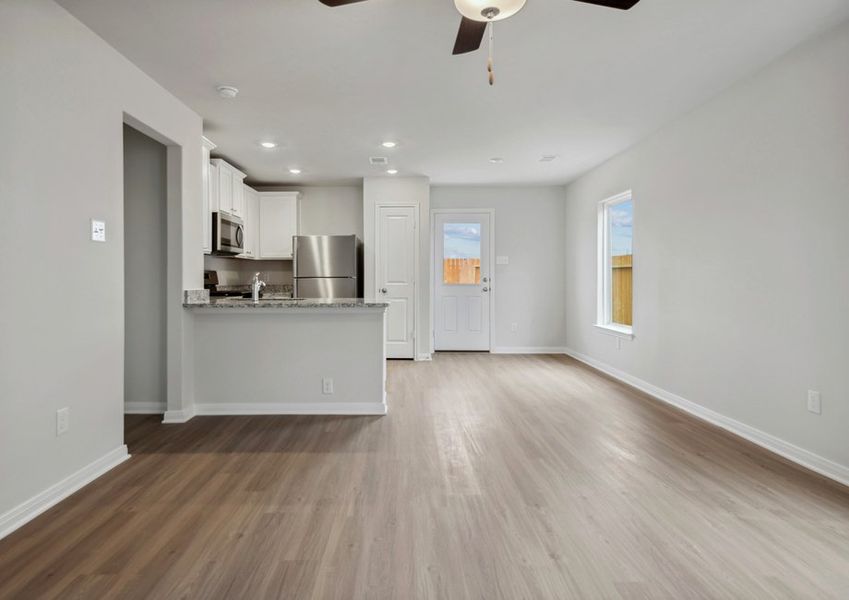 Family room and adjoining kitchen with vinyl flooring