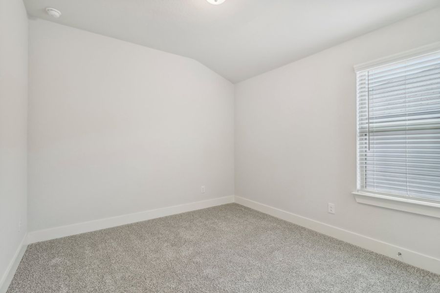 Guest bedroom in the Hughes floorplan at a Meritage Homes community.