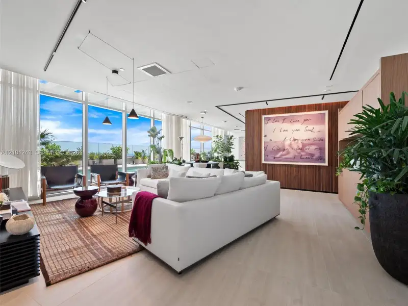 Floor-to-ceiling glass walls, wood-finish flooring, linear track lighting, and a floor-to-ceiling wood-panel feature wall Floor-to-ceiling glass walls, wood-finish flooring, linear track lighting, and a floor-to-ceiling wood-panel feature wall