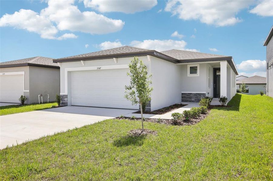 Front exterior of a new home in Benton Hills - Classic Series, Brooksville, FL, highlighting curb appeal (Image 20). Front exterior of a new home in Benton Hills - Classic Series, Brooksville, FL, highlighting curb appeal (Image 20).
