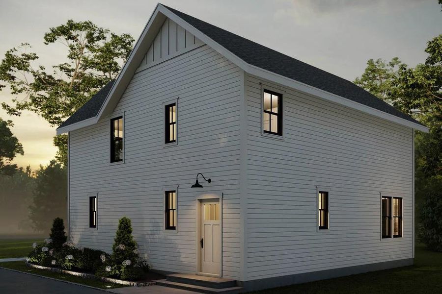 Back of property with a shingled roof