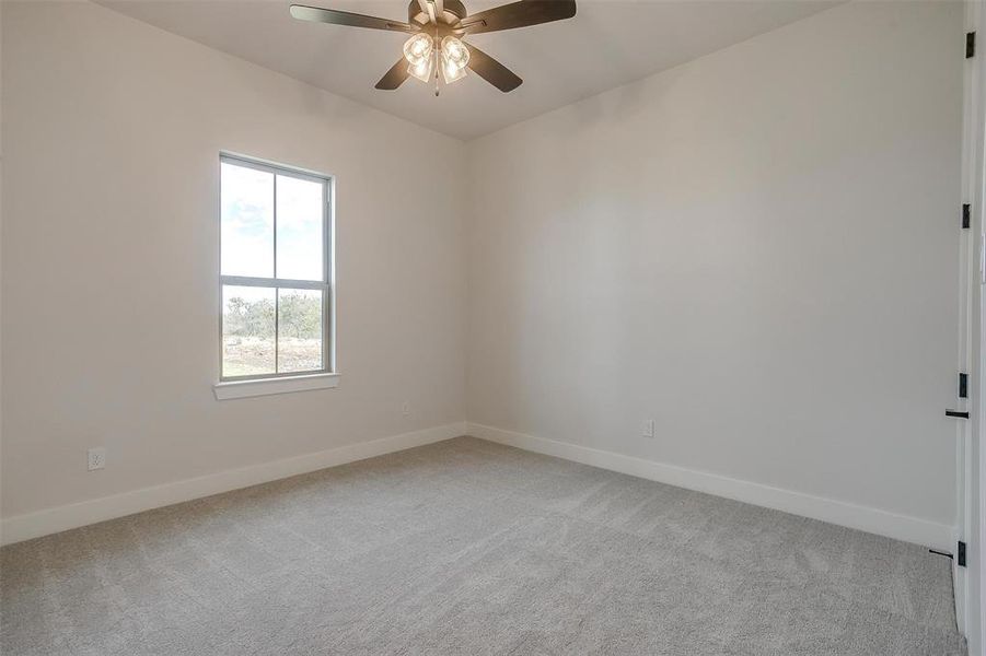 Bedroom 3 with carpet, ceiling fan and large walk in closet.