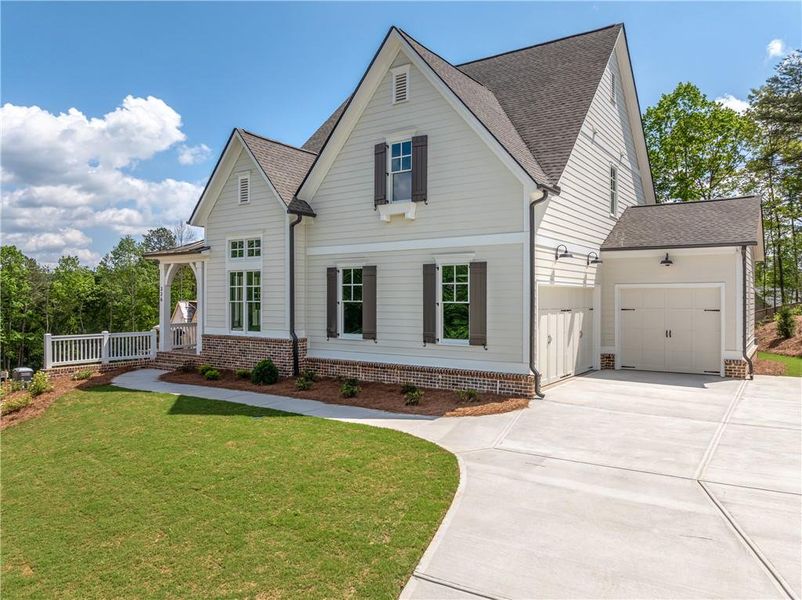 Front exterior of a new home in Malone's Pond, Ball Ground, GA, highlighting curb appeal (Image 1). Front exterior of a new home in Malone's Pond, Ball Ground, GA, highlighting curb appeal (Image 1).