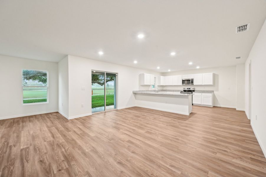 A large kitchen with white cabinets.