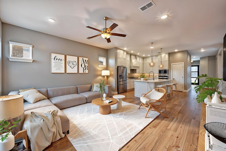 Experience modern living in this virtually staged family room, featuring an open-concept layout with sleek finishes, abundant natural light, and a welcoming atmosphere. Perfect for both relaxation and entertaining.
