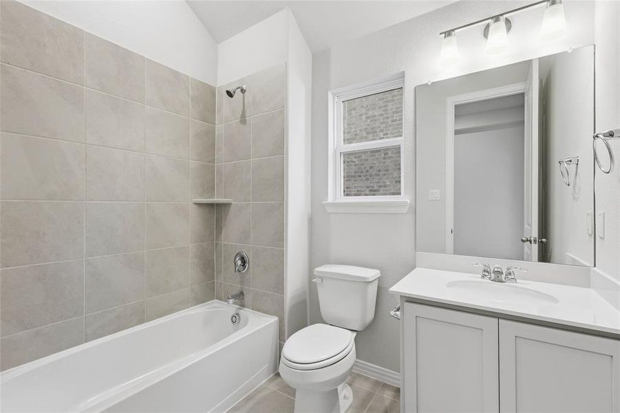 Bathroom with vanity, bathing tub / shower combination, and light tile patterned flooring Bathroom with vanity, bathing tub / shower combination, and light tile patterned flooring