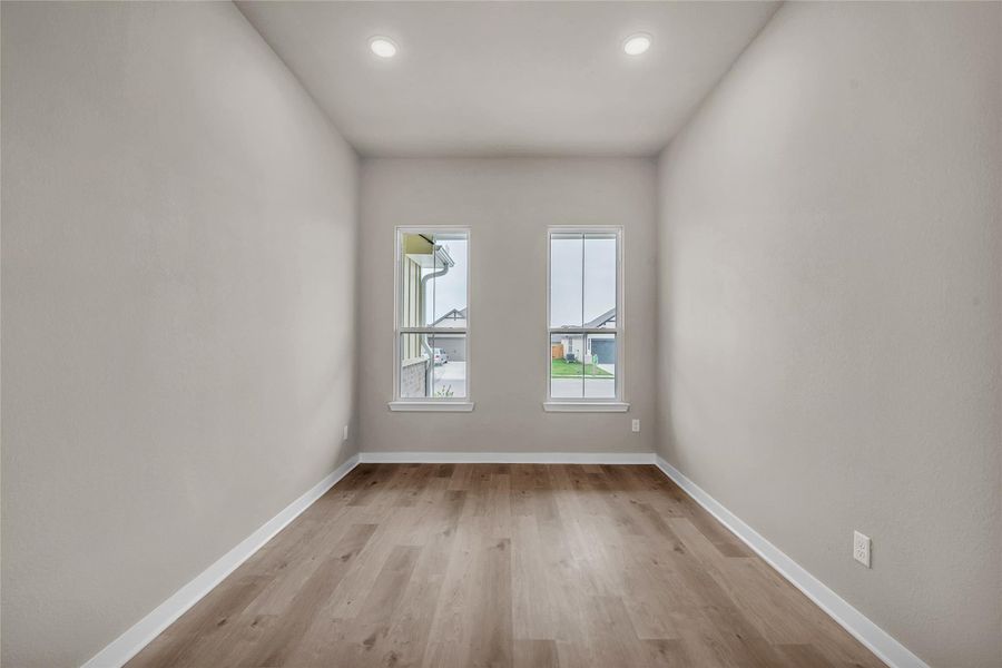 Spare room with light wood finished floors and recessed lighting