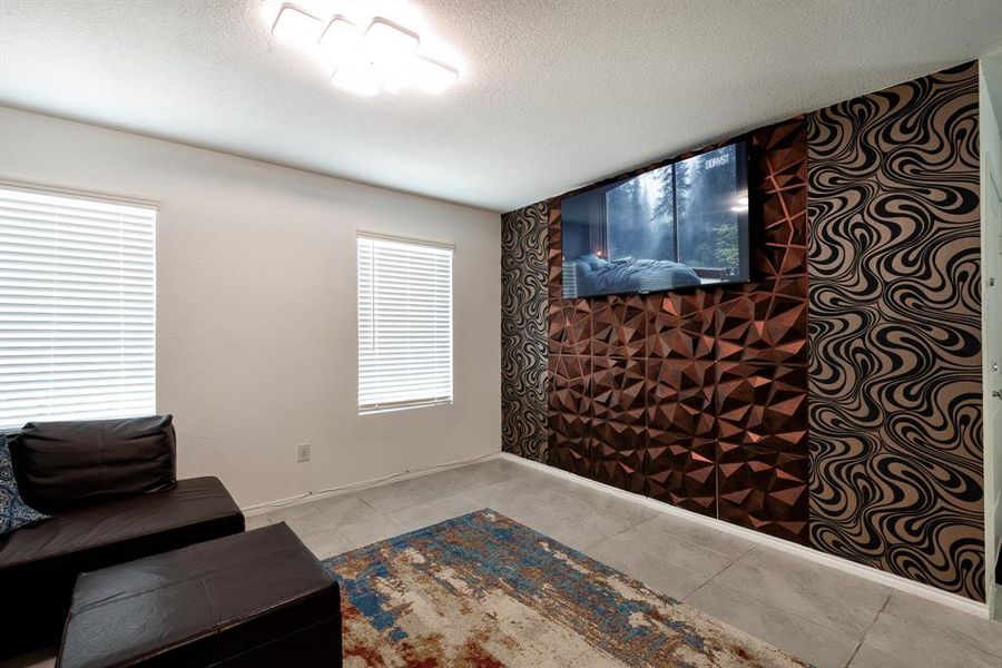 Living area featuring a textured ceiling and light tile patterned floors