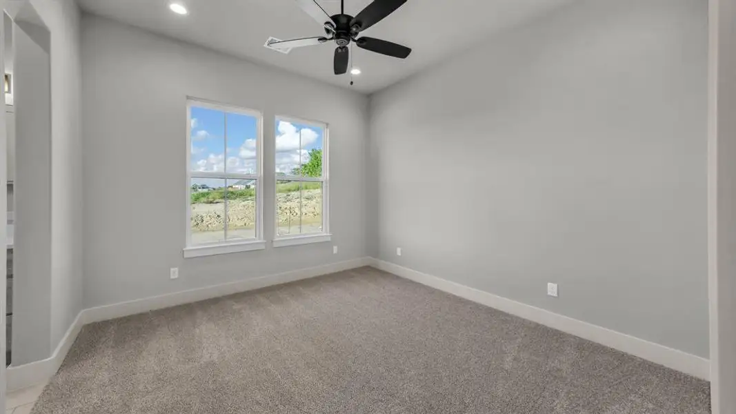Carpeted room with light gray walls, two windows, recessed lighting, and a ceiling fan Carpeted room with light gray walls, two windows, recessed lighting, and a ceiling fan