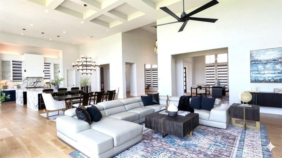Open-concept living area featuring a coffered ceiling, wood-finish flooring, and a contemporary ceiling fan