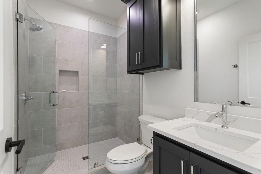 Full bathroom with vanity and a stall shower