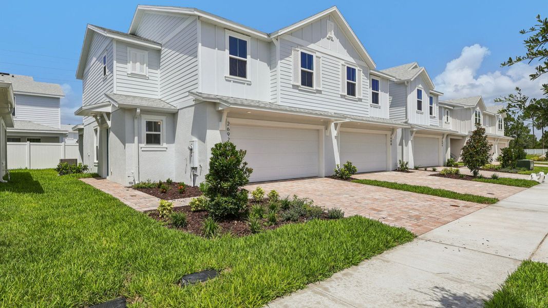 Front exterior of a new home in Cyrene at Harmony, St. Cloud, FL, highlighting curb appeal (Image 2). Front exterior of a new home in Cyrene at Harmony, St. Cloud, FL, highlighting curb appeal (Image 2).