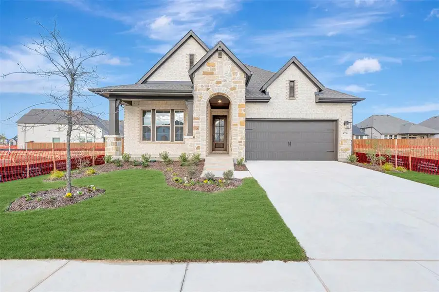 Front exterior of a new home in Sandbrock Ranch, Aubrey, TX, highlighting curb appeal (Image 1).