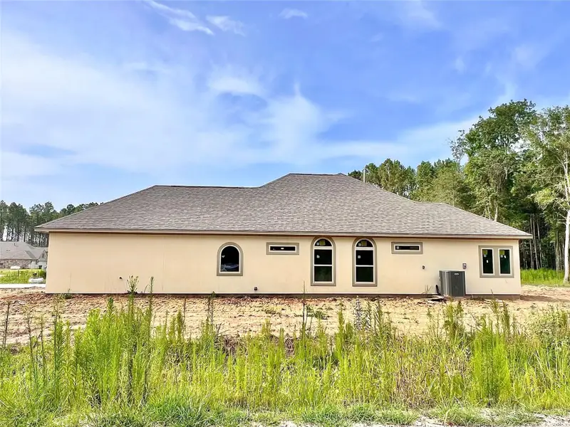 Front exterior of a new home in , Dayton, TX, highlighting curb appeal (Image 1).