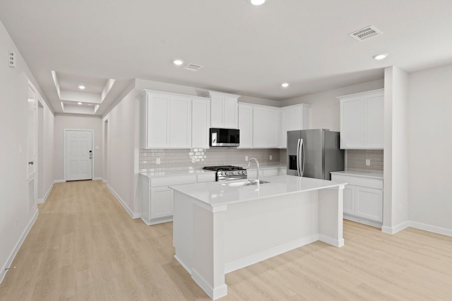 A kitchen with white cabinets. A kitchen with white cabinets.