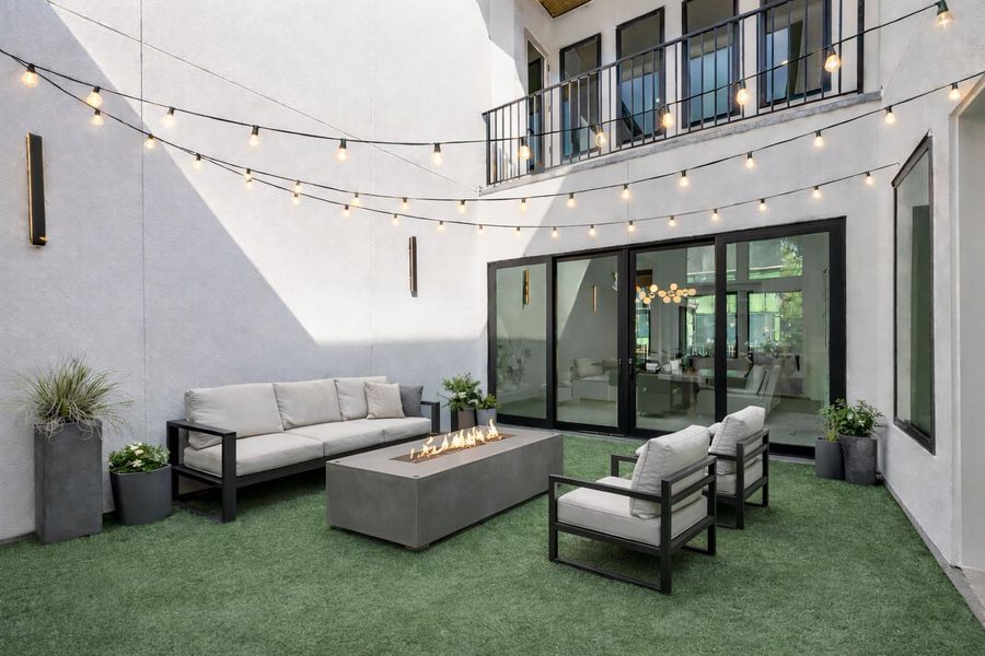 A fully turfed private courtyard, just off the dining room and foyer, offers a rare retreat in the city- destined to be your favorite gathering space and a true showpiece for entertaining. *Virtual representation as an outdoor lounge experience*