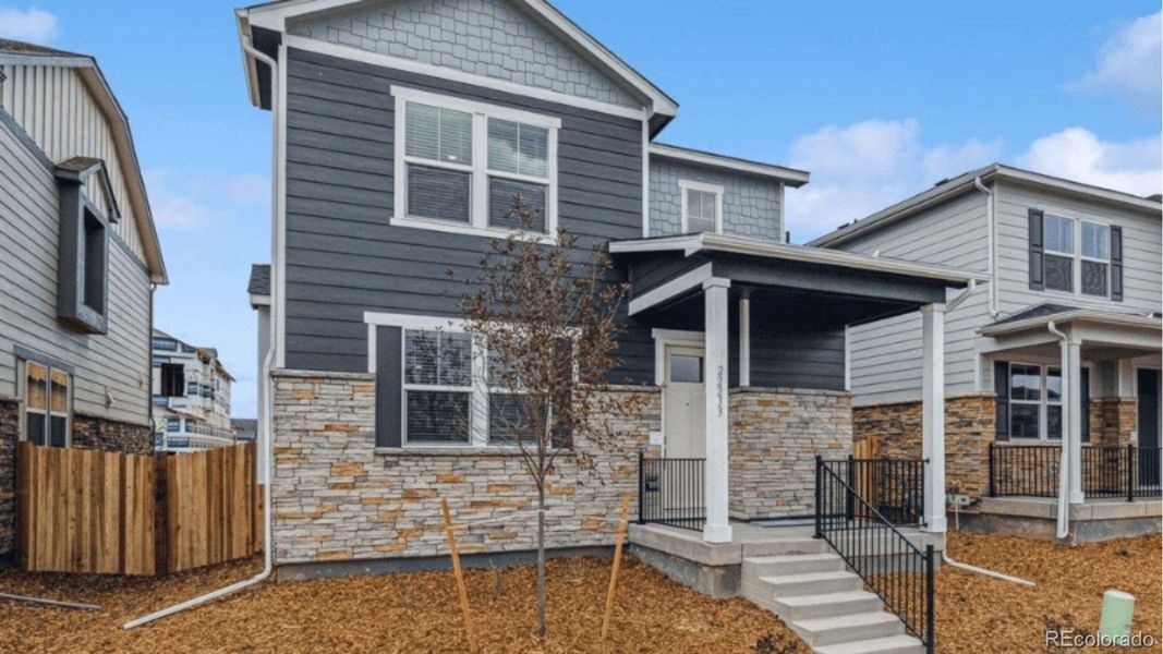 Exterior details and patio area of a home in Horizon Uptown, Aurora (Image 2).