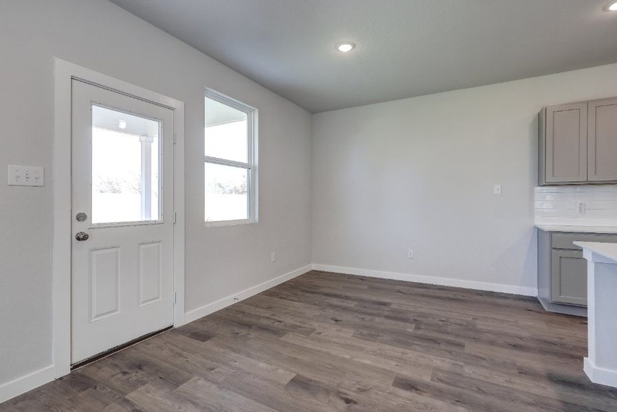 A room with white walls and a wood floor.