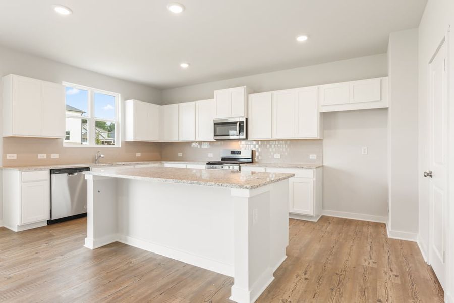 A kitchen with white cabinets. A kitchen with white cabinets.