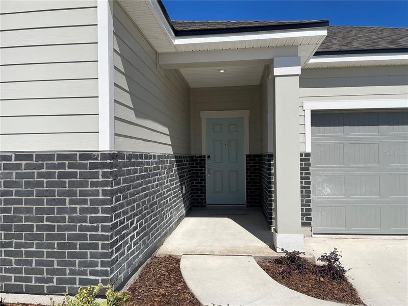 Front exterior of a new home in Magnolia Series at Seminole Palms, Palm Coast, FL, highlighting curb appeal (Image 21). Front exterior of a new home in Magnolia Series at Seminole Palms, Palm Coast, FL, highlighting curb appeal (Image 21).