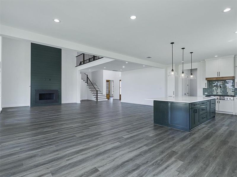 The fireplace in the living room features eye-catching accent walls made of wood adding a touch of modern farmhouse charm.
