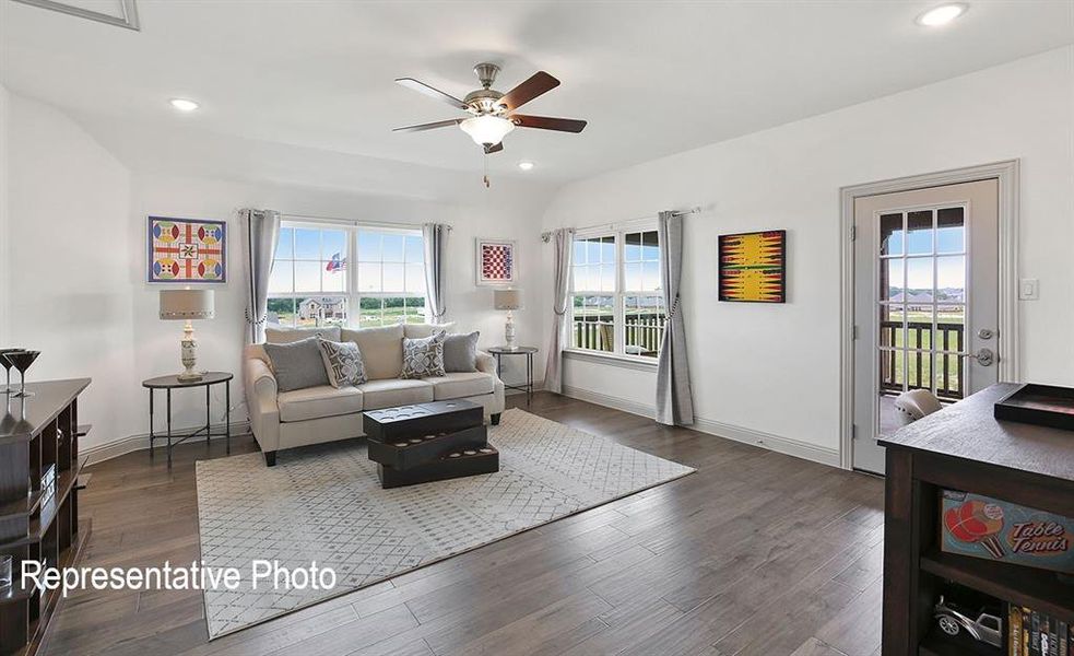 Spacious living area featuring wood-finish flooring, recessed lighting, and a ceiling fan