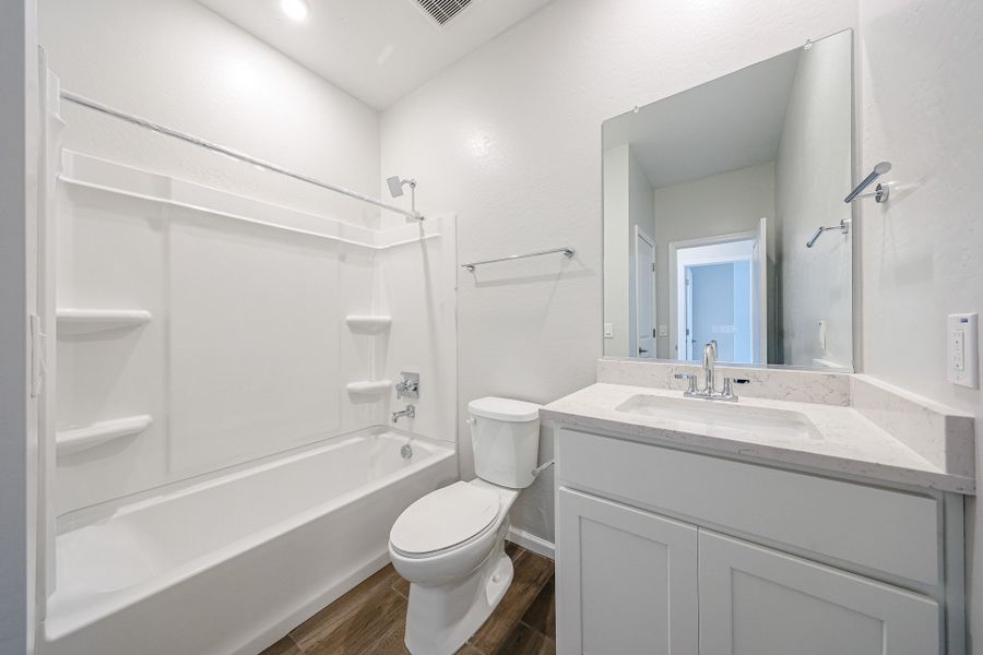 A bathroom with a tub toilet and sink.