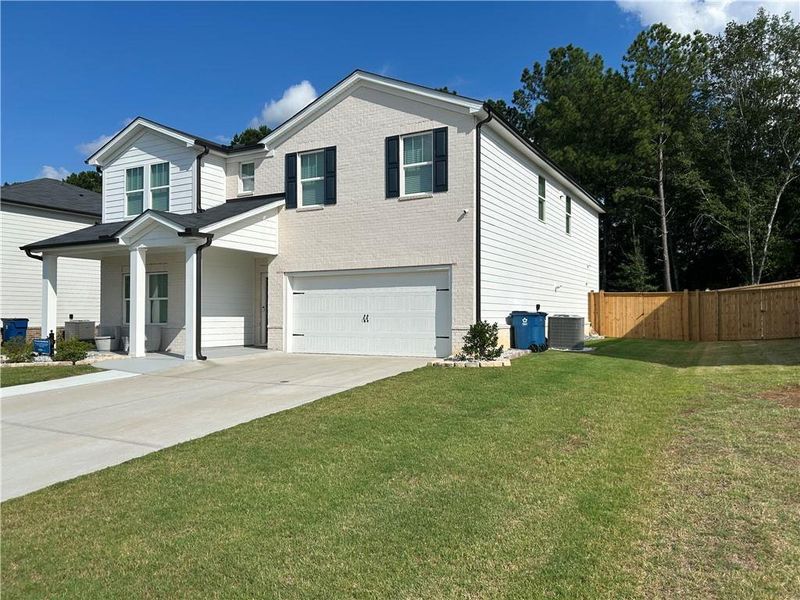 Front exterior of a new home in , Loganville, GA, highlighting curb appeal (Image 22).