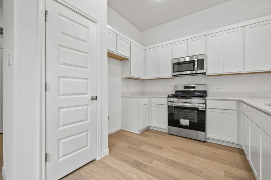 Kitchen in the Birch home plan by Trophy Signature Homes – REPRESENTATIVE PHOTO