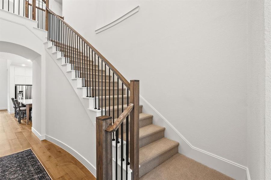Stairs with arched walkways and engineered wood finished floors Stairs with arched walkways and engineered wood finished floors