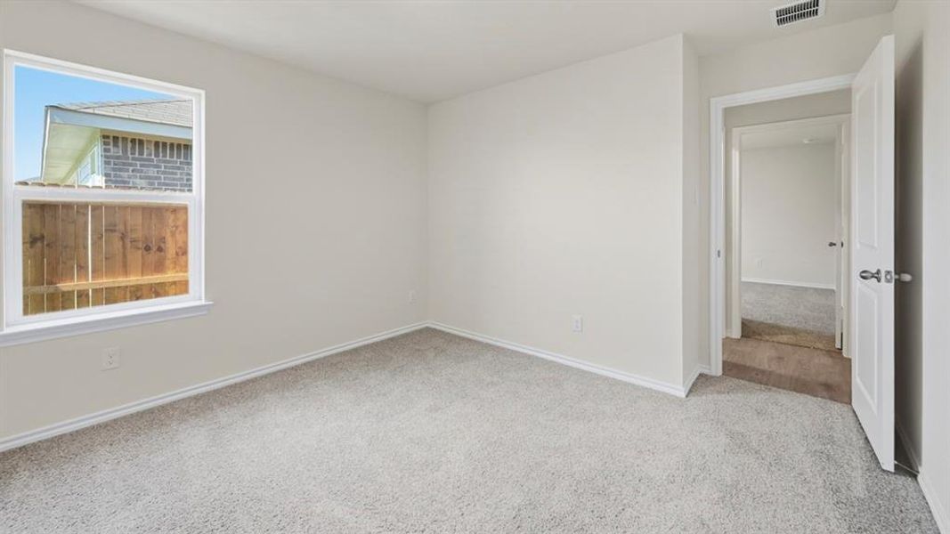 Empty room with carpet floors and baseboards Empty room with carpet floors and baseboards