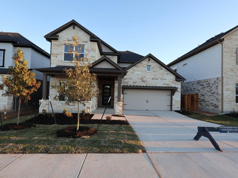 Front exterior of a new home in Edgewood, Leander, TX, highlighting curb appeal (Image 21).
