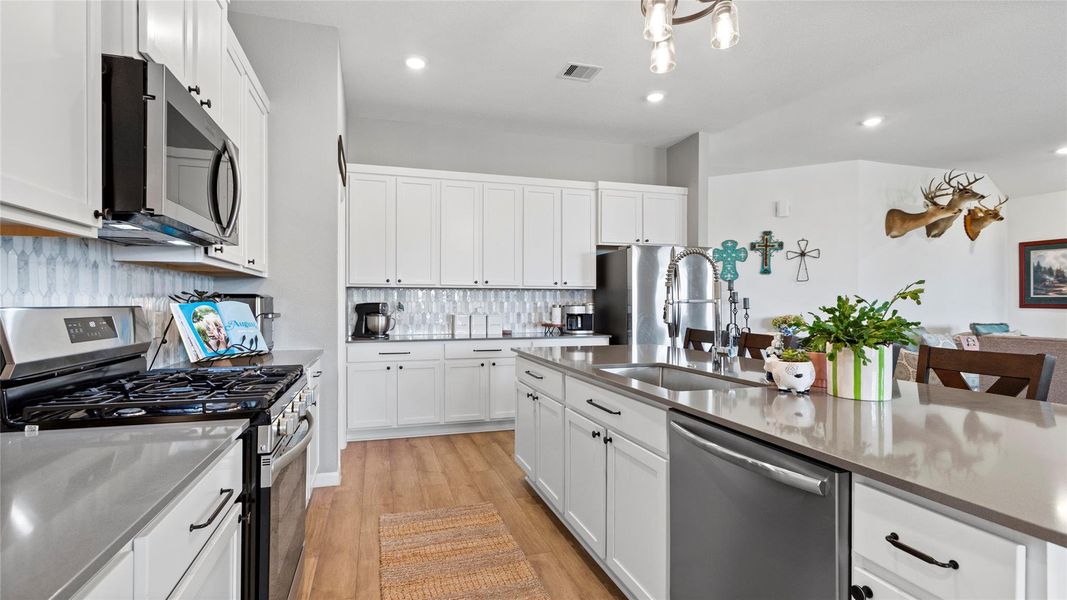 Discover the heart of this home with a stunning kitchen, featuring sleek countertops, modern appliances, and ample cabinetry, perfect for culinary adventures and gatherings. Discover the heart of this home with a stunning kitchen, featuring sleek countertops, modern appliances, and ample cabinetry, perfect for culinary adventures and gatherings.