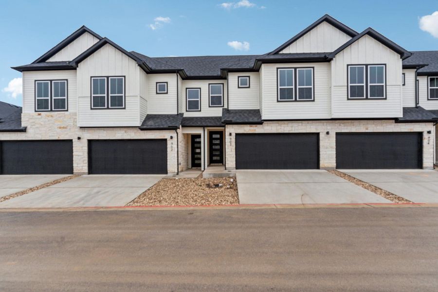 Front exterior of a new home in Townhomes at Gattis, Round Rock, TX, highlighting curb appeal (Image 2). Front exterior of a new home in Townhomes at Gattis, Round Rock, TX, highlighting curb appeal (Image 2).