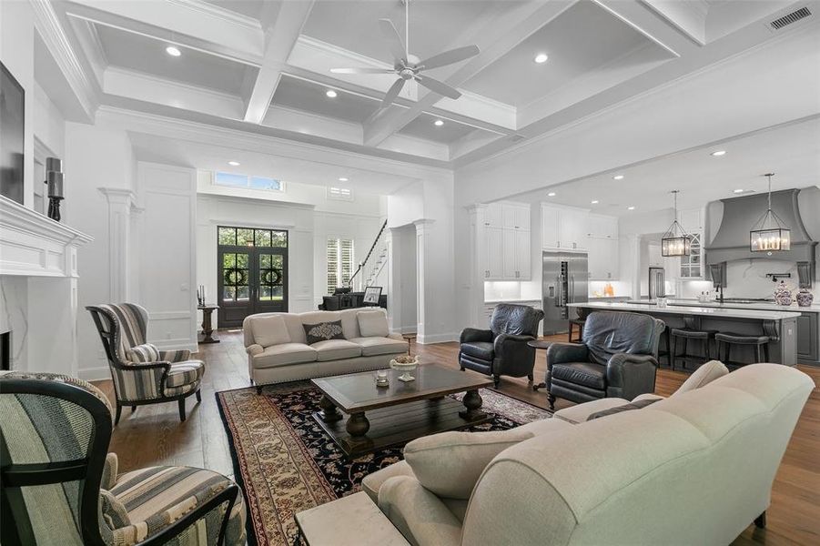 Looking from the Family room to the kitchen and foyer. This open floor plan will absolutely make entertaining your guests a breeze!