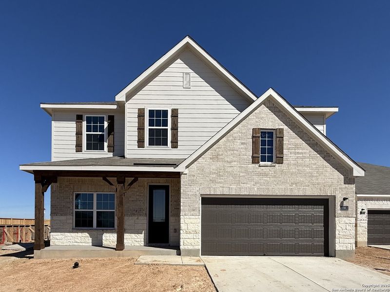 Front exterior of a new home in The Preserve at the Wilder, Adkins, TX, highlighting curb appeal (Image 1).