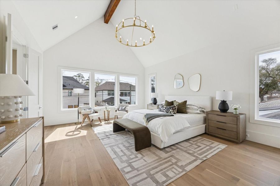 Spacious retreat with a vaulted ceiling, soft natural light, and room for a full sitting area.