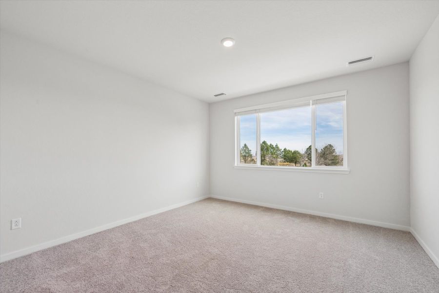 A room with a window and a view of the water.