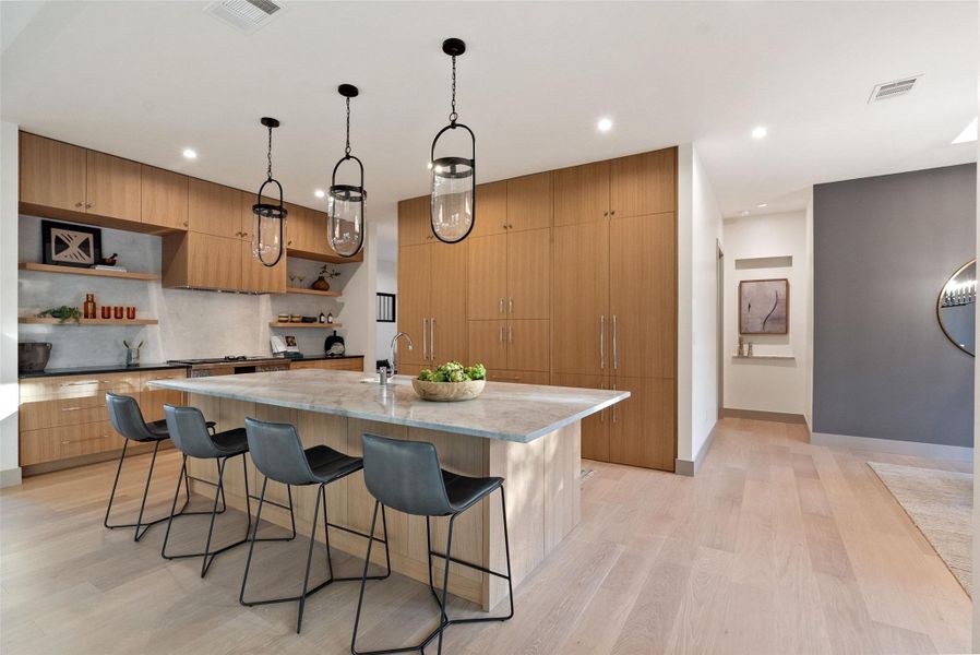 Hidden pantry doors disappear into wall of cabinets.