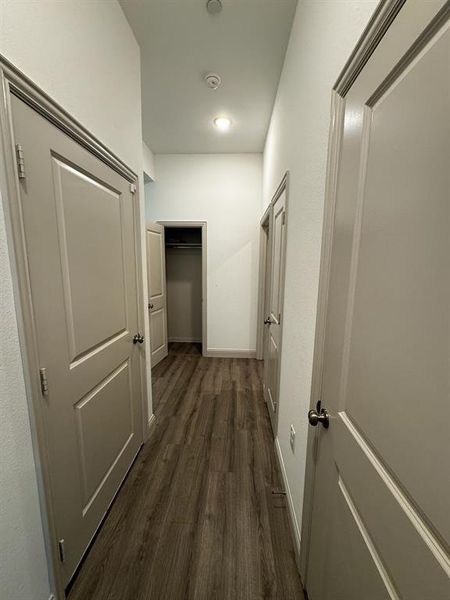 Corridor with dark hardwood / wood-style floors