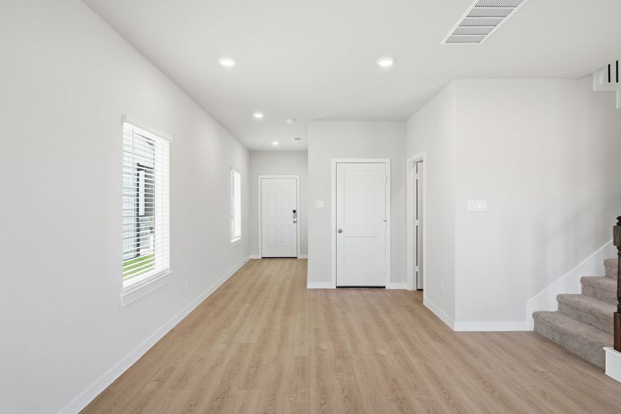 A room with white walls and a wood floor.