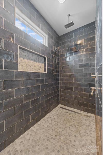 primary cave/walk in shower with 3 heads
