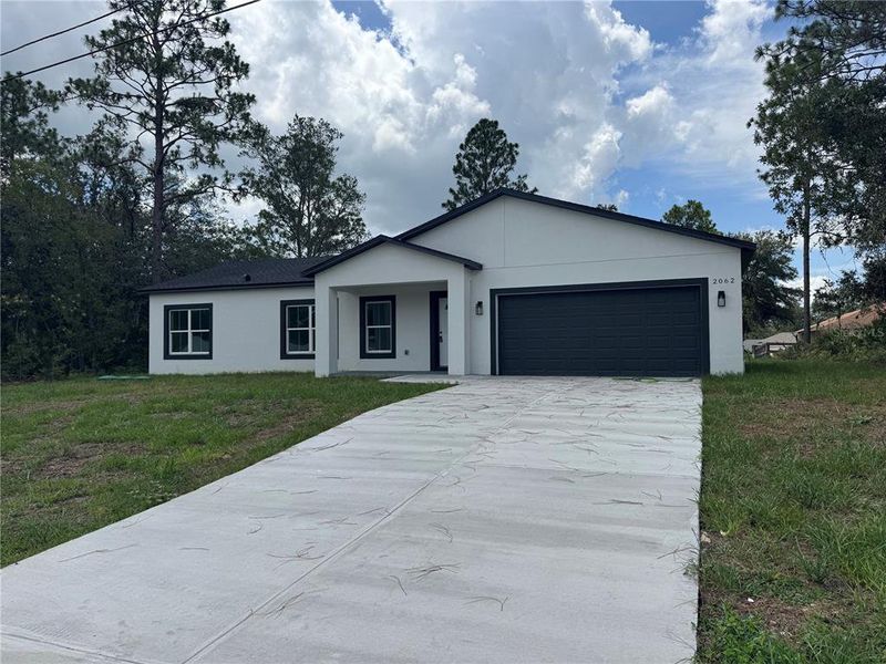 Front exterior of a new home in , Dunnellon, FL, highlighting curb appeal (Image 12).