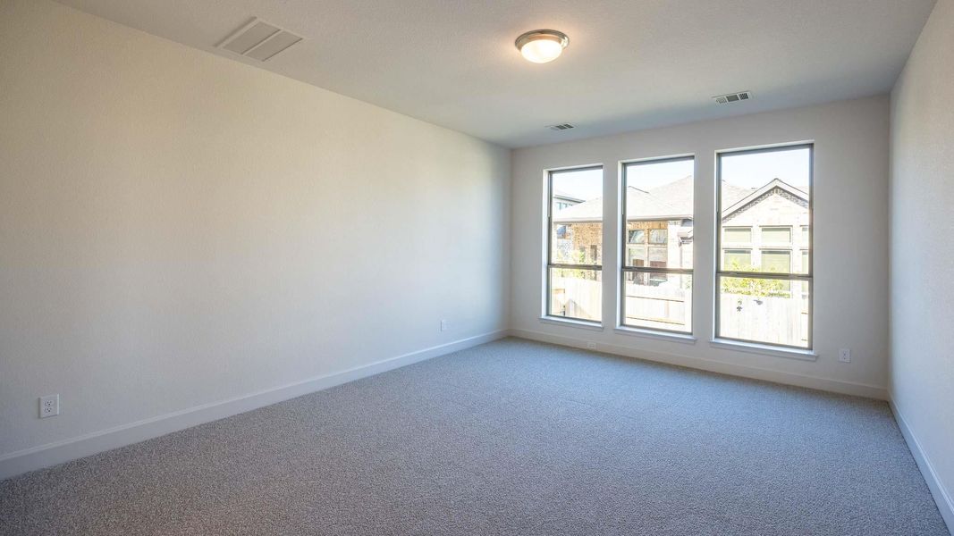 Carpeted spare room with baseboards Carpeted spare room with baseboards