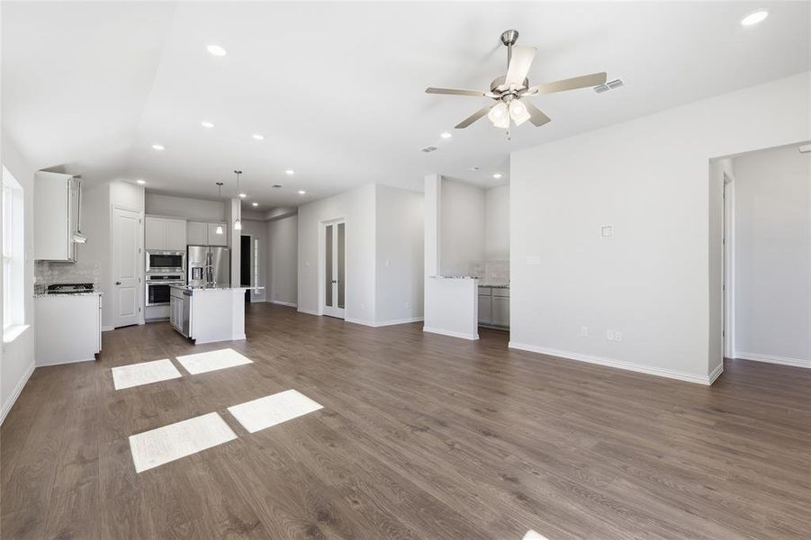 Unfurnished living room with recessed lighting, dark wood-type flooring, and ceiling fan Unfurnished living room with recessed lighting, dark wood-type flooring, and ceiling fan