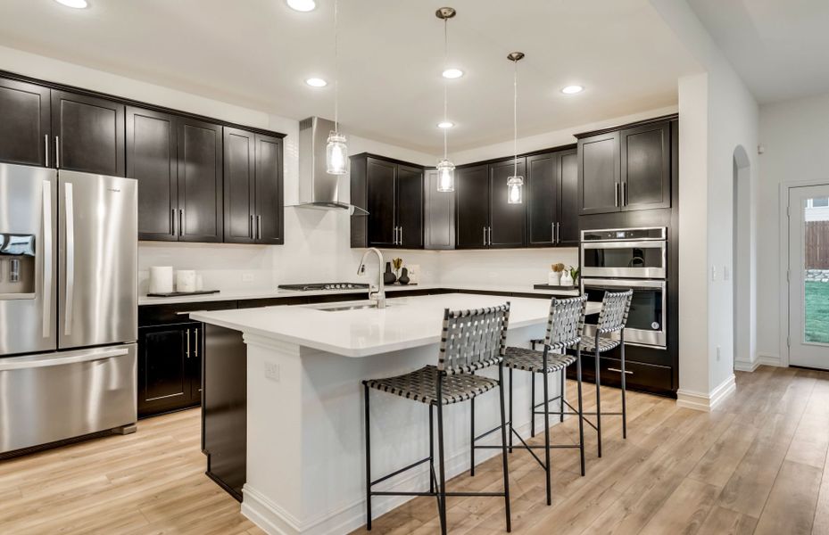 Gorgeous pendant and recessed lighting at kitchen